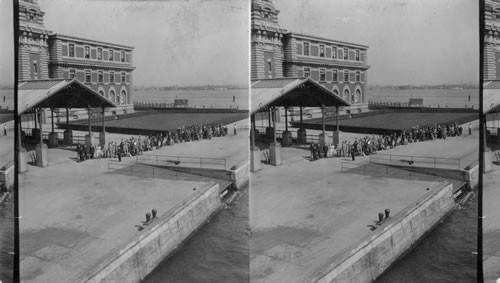 Immigrants from Europe entering Immigration Building from Boat, Ellis Island. New York Harbor