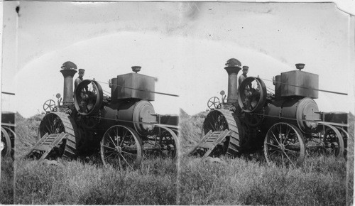 Steam power reaper and thresher cutting a wide swath in the Idaho wheat fields. Idaho