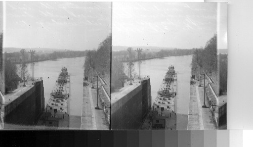 Boat and oil barges entering the lock