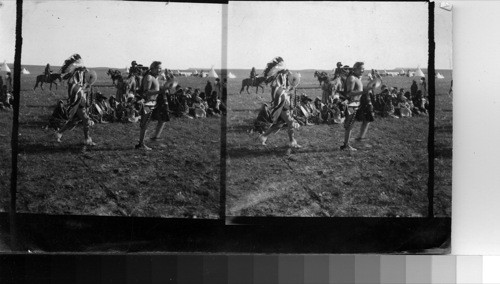 Indians Preparing Camp to be used in the Sham Battle, and Aiming Rifles directly at the photographer in sport. Fort Belknap Reservation, Mont., July 1906