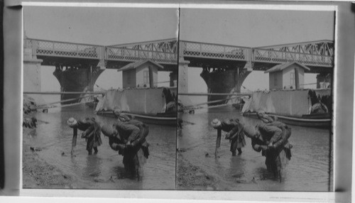 Water carriers filling their goat skins in the Nile