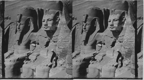 The sixty-five foot portrait statues of Ramses II before rock-hewn temple of Abu Simbel. Egypt