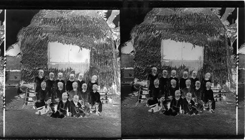 Filipino children outside a native schoolhouse. Philippine Islands