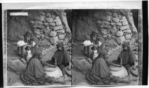 Jericho women grinding at the mill, Palestine