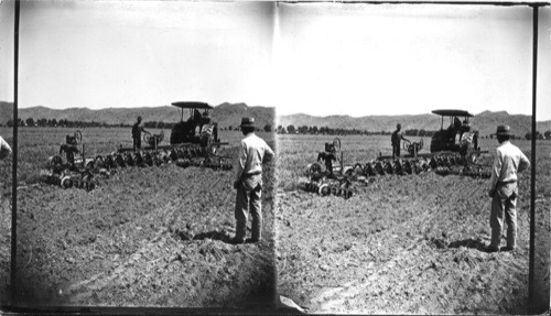 Plowing old alfalfa field with 12-28 "disk plows." Salt river valley, Phoenix, Arizona