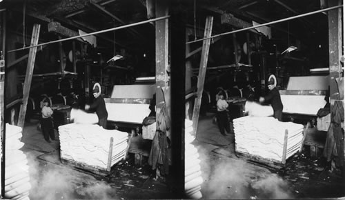 Presses at work and trucks loaded with sheets of pulp. - Maine