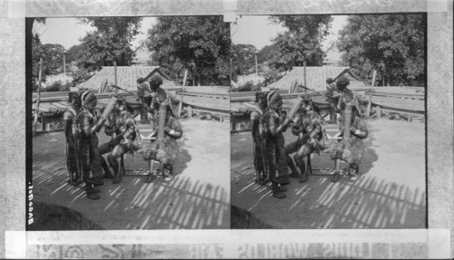 A Pretty Group of Bagobas Indian Maidens Dancing to their music, Philippine Village. St. Louis World's Fair