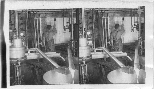 Milk in the separating room passing over refrigerating pipes of a dairy. Central N. York