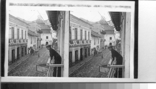 A pretty neighbor taking the air on a balcony overlooking Bolivar St. Quito, Ecuador