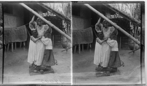 Helping Mamma Iron The Clothes - A Filipino Method, Island of Luzon. P.I