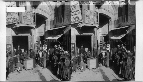 Among changer and his patrons just inside the Jaffa gate at Jerusalem. Palestine