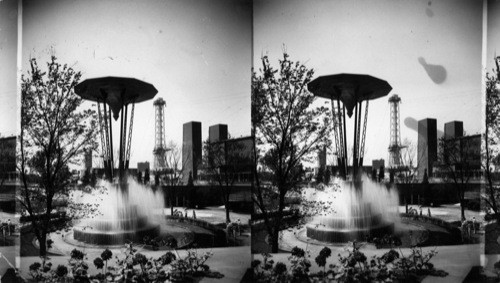 Fountain in the Court of the Electrical Building. Hall of Science seen across the Lagoon