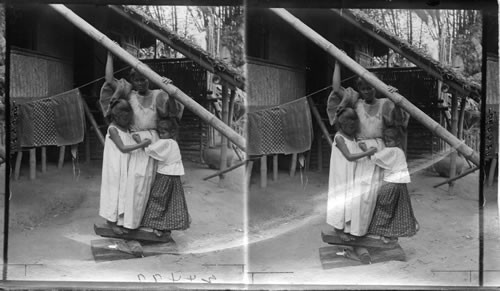 Helping Mamma Iron The Clothes - A Filipino Method, Island of Luzon. P.I