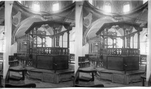 Inside a Jewish synagogue showing holy place and readers platform. Jerusalem. Palestine