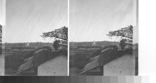 Belleau Wood from village. Memorial and cemetery seen just over roof of one of temporary buildings typical of Belleau construction (south). Looking from Velleau Village south to Belleau Wood and the American military cemetery today