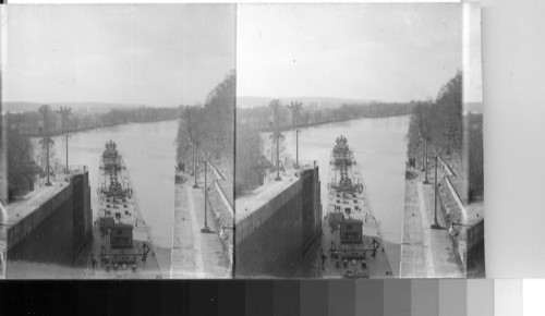 Boat and oil barges leaving the lock going down the river with boat and barges of oil waiting to enter the lock. Sampson