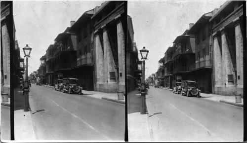 Typical street scene in French Quarter, New Orleans. White building at right was an old Spanish arsenal. The brick building next beyond and with closed blinds was the house of Andrew Jackson