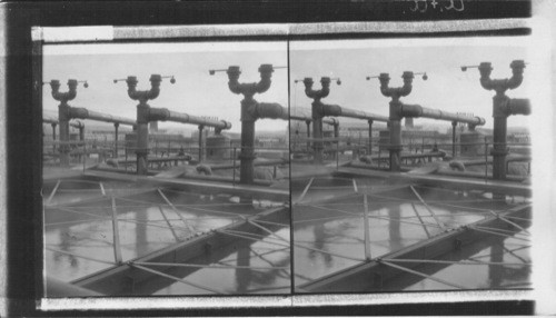 Water Tanks Where Vaporized Oil in Pipes Cools and Condenses. West Tulsa, Oklahoma