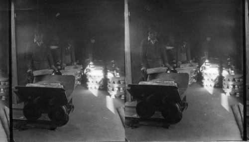 Loading freight car with bullion bars for shipment - about 900 bars in a freight car. Leadville, Colo. Mostly lead, some gold and silver