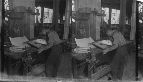 Man laying out a piece of pulp, mill machinery. Ship Building Co., Port Arthur, Ont