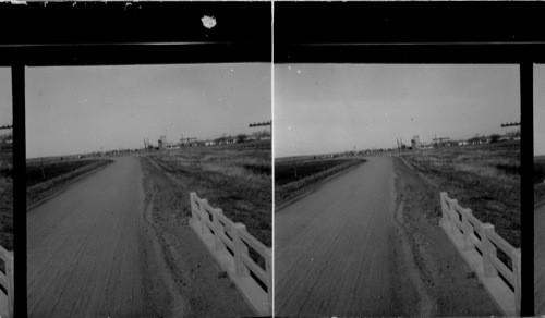 A Small Railroad Town, East Kansas. (When [grain] elevators and stock run, shown.) [In the very far distance.]