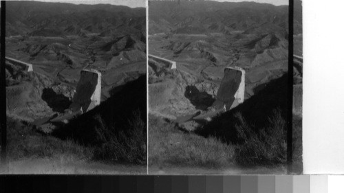 Looking down on the dam from the highway on the south side of the canyon. Wrecked dam and section of the reservoir