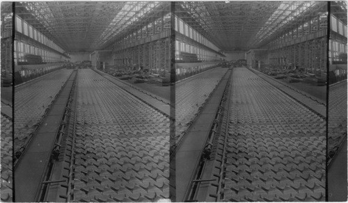 Cooling Bed, Here is where the Rods or Billets as they come from the Rolling Mill are placed to cool. One Man can operate both sides of this Cooling Bed. This bed is made up of Rockers which turn lifting the rods from one place and setting on the next rocker. Ford Motor Plant, Detroit, Mich