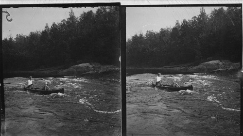 Shooting Rapids with canoe at Moon Dam Rapids on Moon River, Muskoka Lakes, Canada