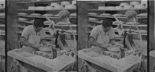 Worker giving perfect shape to the plate by means of a "profile" (a hard tool made of porcelain) "Lenox Inc." makers of fine chinaware, Trenton, N.J