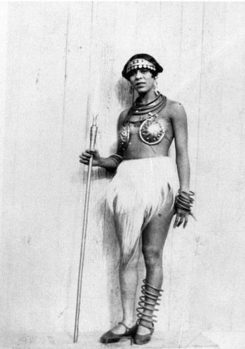 Woman in costume holding spear