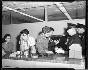 Robbery suspects at police building, 1957