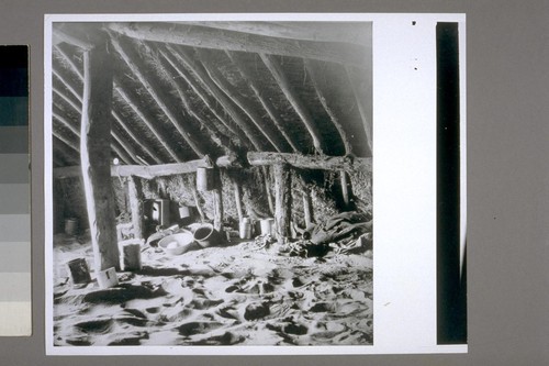 Interior of house, seen from one of the corners opposite the door