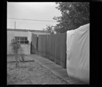 Towels and sheets hanging from a clothesline in the West's back yard, [Los Angeles], 1941