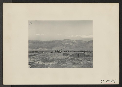 Manzanar, Calif.--View of construction of water reservoir at Manzanar, a War Relocation Authority center where evacuees of Japanese ancestry will be housed for the duration. Photographer: Stewart, Francis Manzanar, California