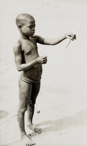 Girl with spinning top, Nigeria, ca. 1938