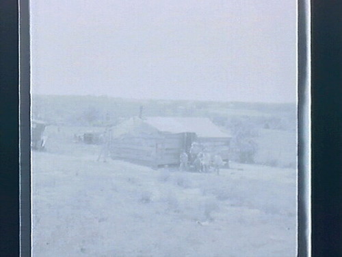 Oklahoma - houses & fellow reading paper on steps