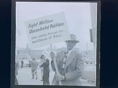 1.) newspaper stand (headline "Japan Treaty...Today Gremyko Block Pact) 2.)Street Demonstrations Against Conference