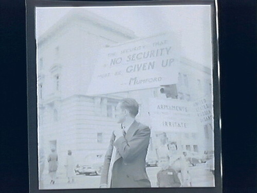 1.) newspaper stand (headline "Japan Treaty...Today Gremyko Block Pact) 2.)Street Demonstrations Against Conference