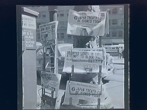 1.) newspaper stand (headline "Japan Treaty...Today Gremyko Block Pact) 2.)Street Demonstrations Against Conference