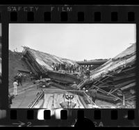 Emergency and construction workers on collapsed bridge on the San Bernardino and San Gabriel River Freeways, Los Angeles, 1970