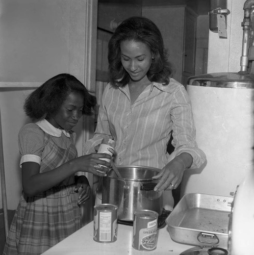 Big Sister program participants cooking together, Los Angeles, 1976