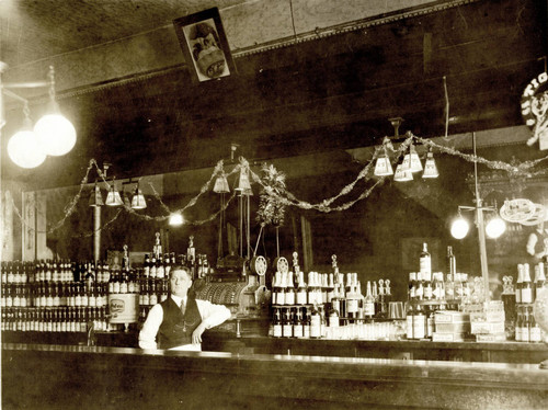 Bartender behind Ornate Bar