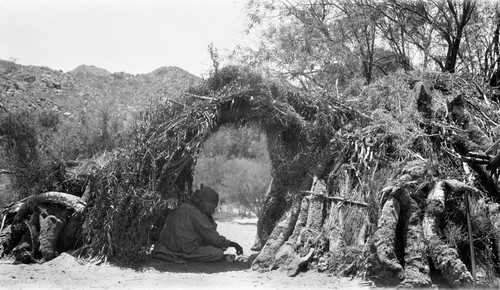 A Kiliwa house (wa'), of the original primative type, made of weeds, boughs, and yucca trunks lashed to a framework of poles