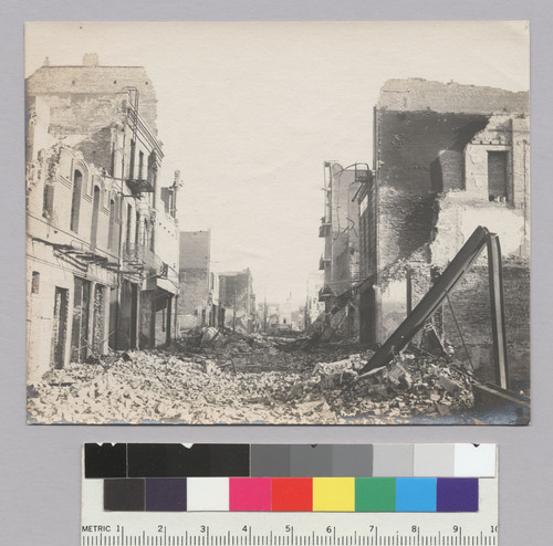 [Street scene showing rubble and ruins, unidentified location.]