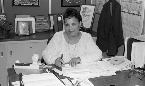 Lucille Boswell posing at her office desk, Los Angeles, 1986