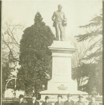 A.J. Stevens fountain in Plaza Park with seven men seated at the base of the fountain