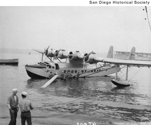 Sailors carrying a walkway to a Pan American Clipper seaplane