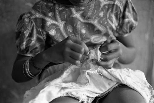 Girl sewing a garment, San Basilio de Palenque, 1977