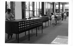 Patrons using the card catalog in the library, Santa Rosa