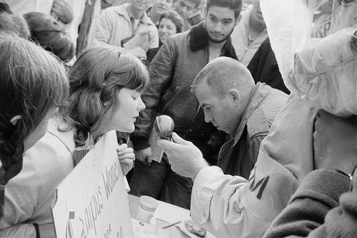 Crowd surrounding Campus Women for Peace table in Sproul Plaza